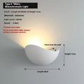 Black bird's nest design LED courtyard lamp with IP65 waterproof rating on a garden wall.