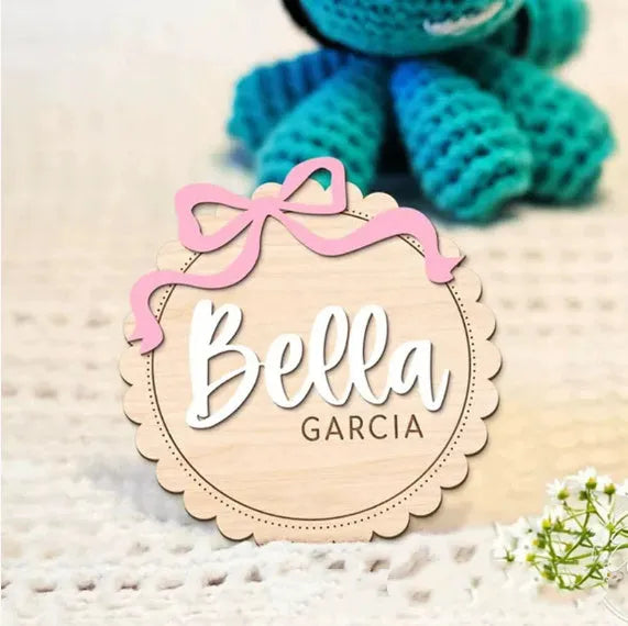 Square wooden baby ornament personalised with a custom name for nursery decor.