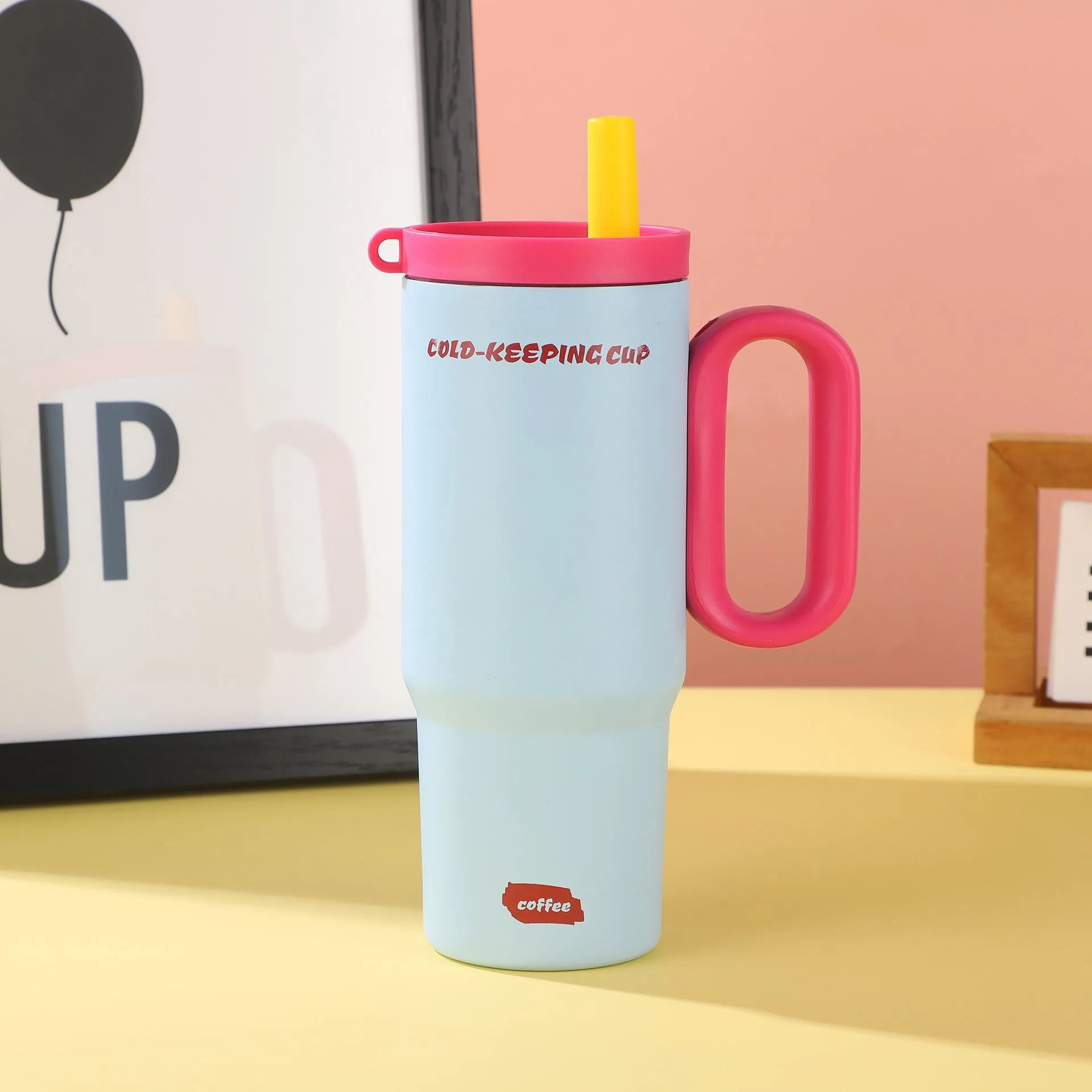 Portable plastic ice bucket with handle and large capacity, shown with a straw cup, for outdoor drink cooling.