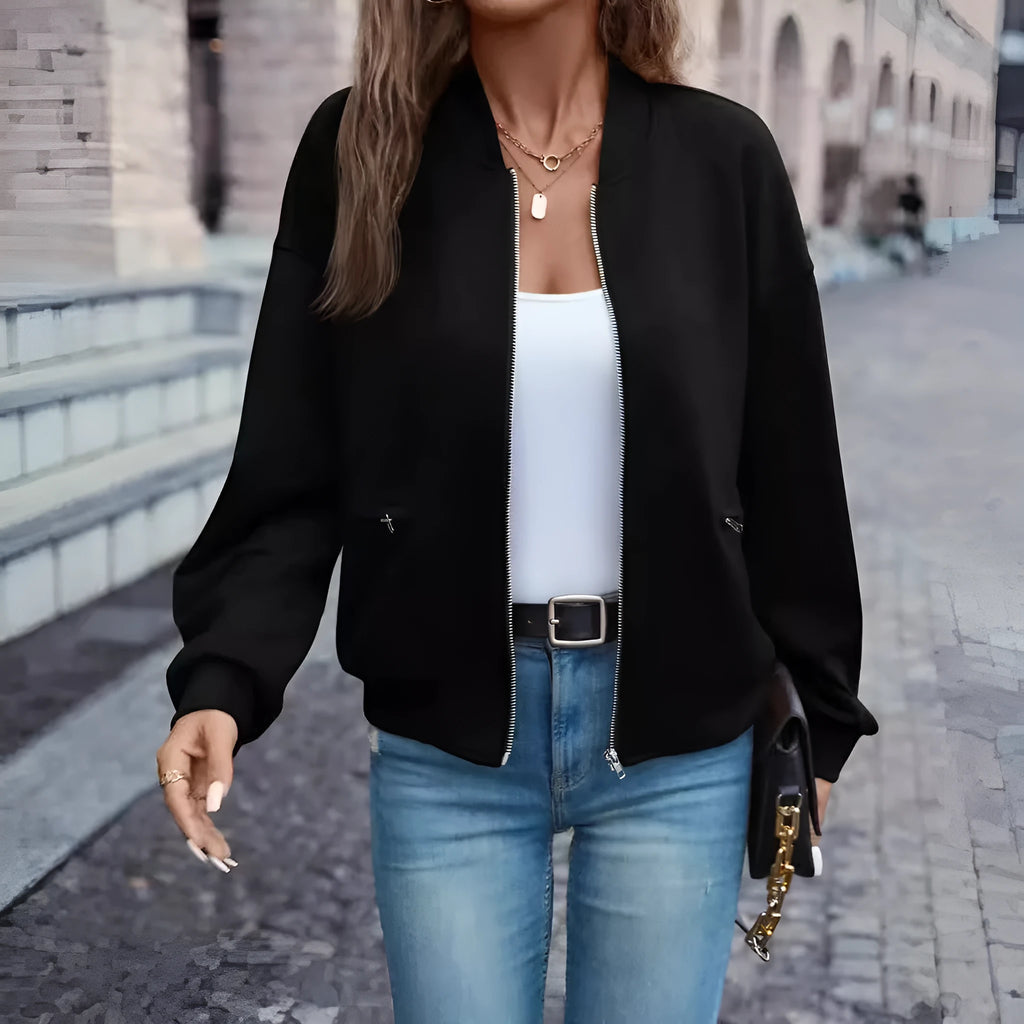Black women's casual zip jacket with long sleeves on a hanger