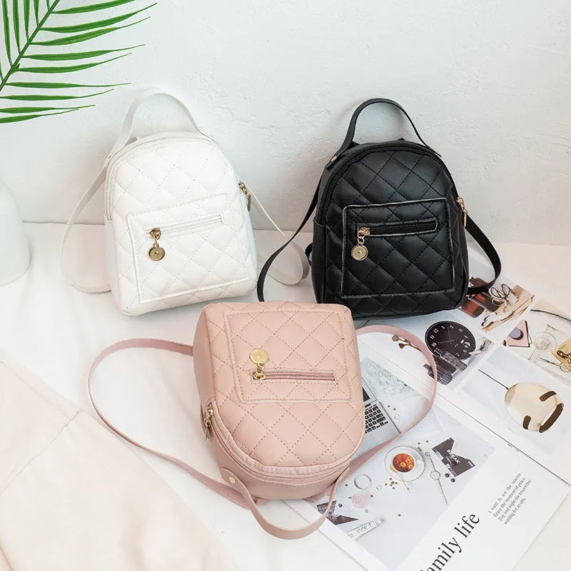 Girls' hard backpack with embroidery in white, black, or pink colours, showing sandwich pocket and soft handle