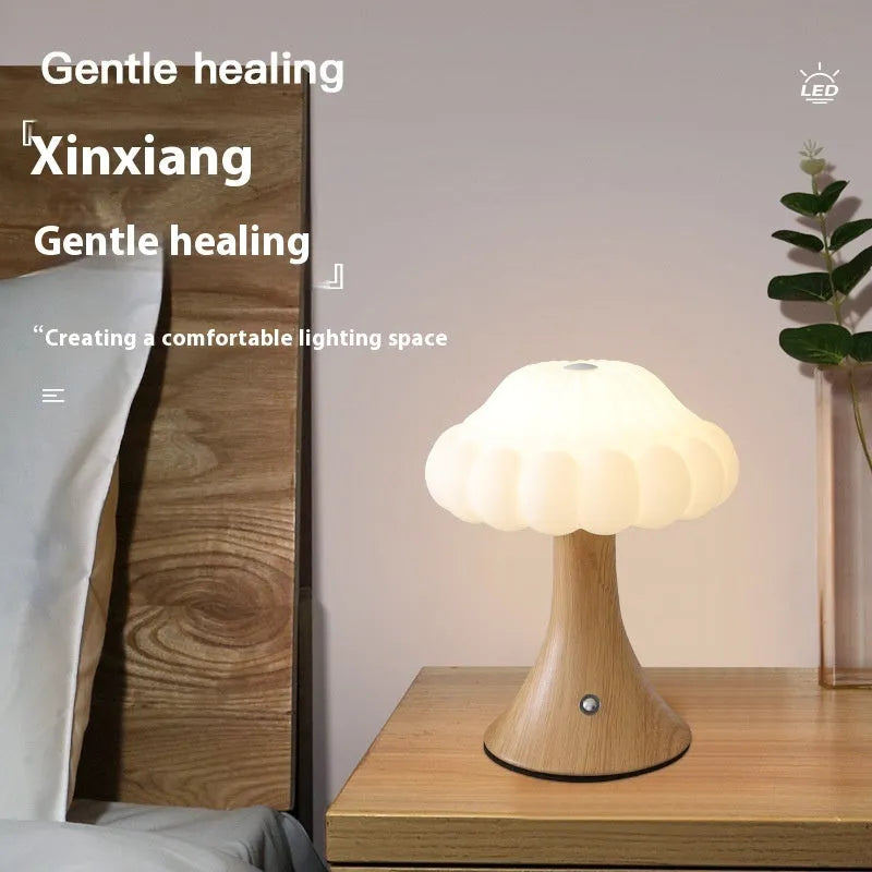 Mushroom-shaped charging touch night light in five colour options on wooden table