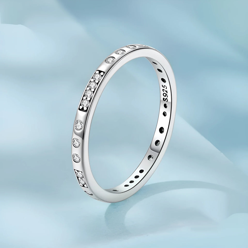 Sterling silver I Love You ring with oxidised black finish and moss knot design on a finger.