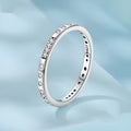 Sterling silver I Love You ring with oxidised black finish and moss knot design on a finger.