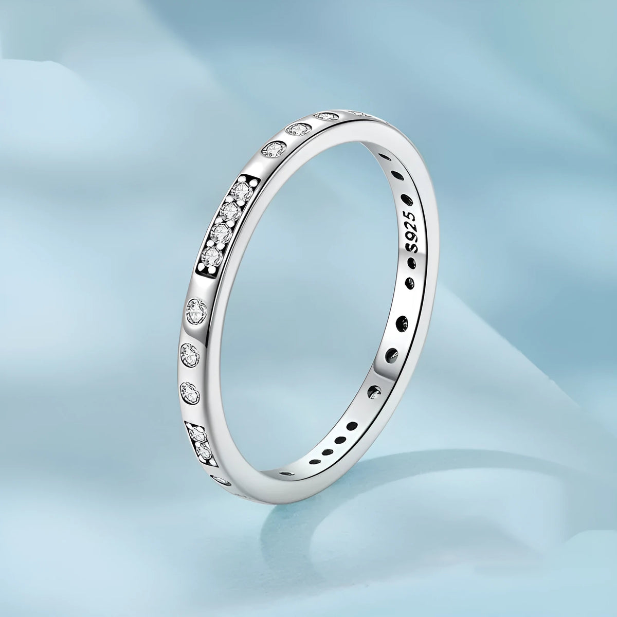 Sterling silver I Love You ring with oxidised black finish and moss knot design on a finger.