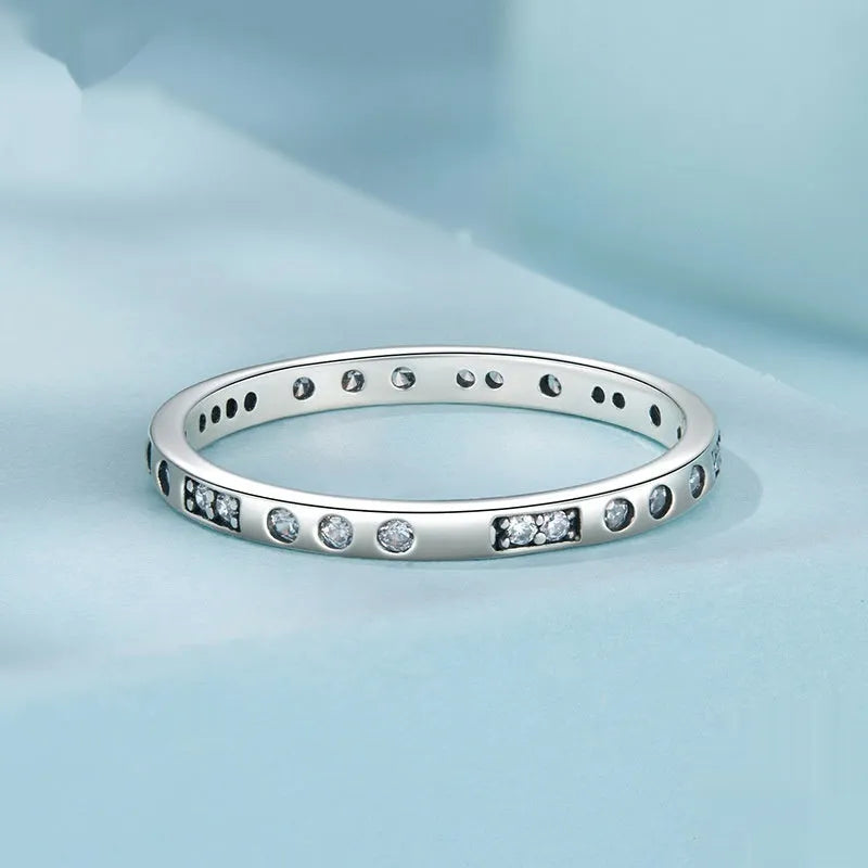Sterling silver I Love You ring with oxidised black finish and moss knot design on a finger.