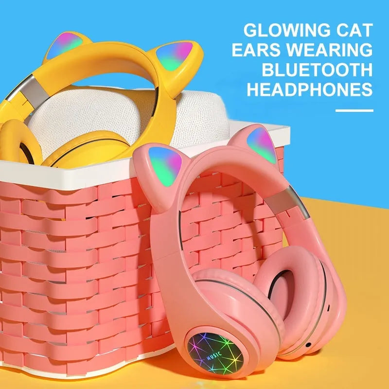 Colourful cat ear style wireless Bluetooth sports headset with a headband, shown in pink.