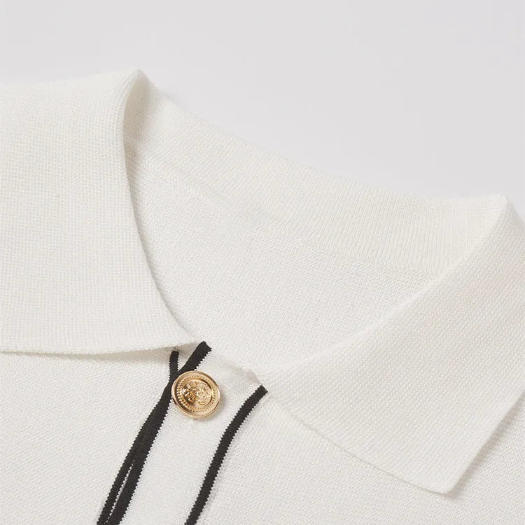 White women's short sleeve cardigan with dark contrast lapels on the collar.