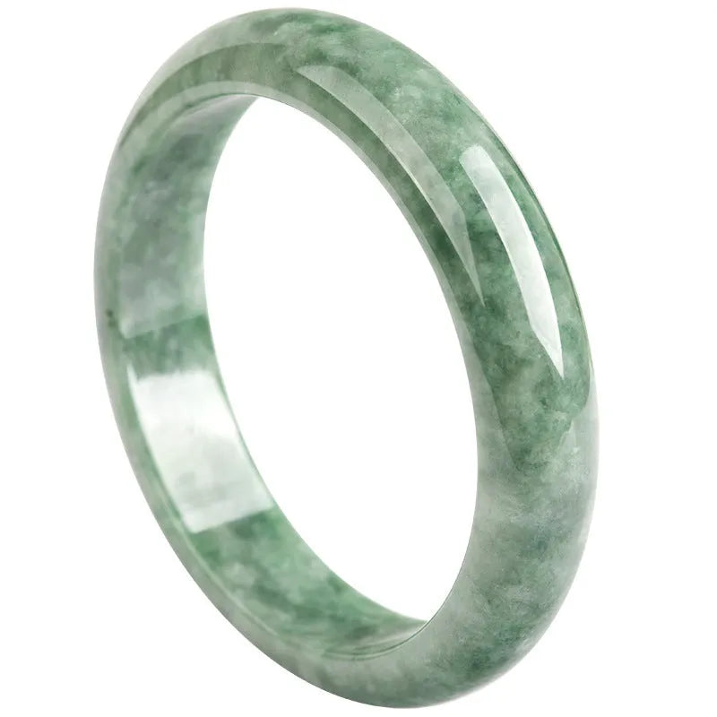 Natural emerald green stone bracelet for women on a wrist, presented with its certificate and gift box.