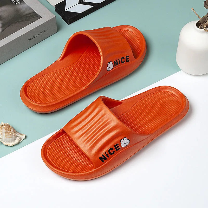 Pair of adult EVA flip flop slippers with a cartoon pattern on a non-slip sole, shown in one of six available colours.