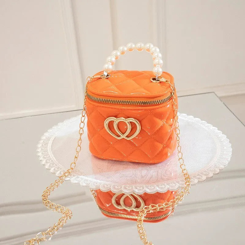 PVC bucket gel handbag with heart pattern in apricot colour showing flexible jelly construction
