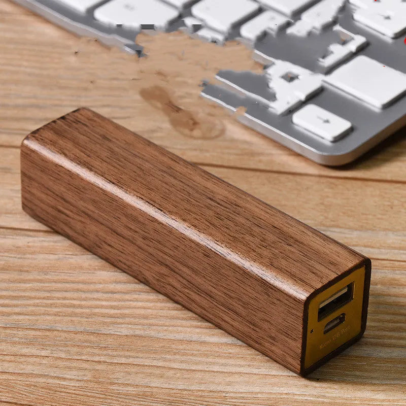 Brown walnut wood portable power bank with USB port showing compact rectangular design.