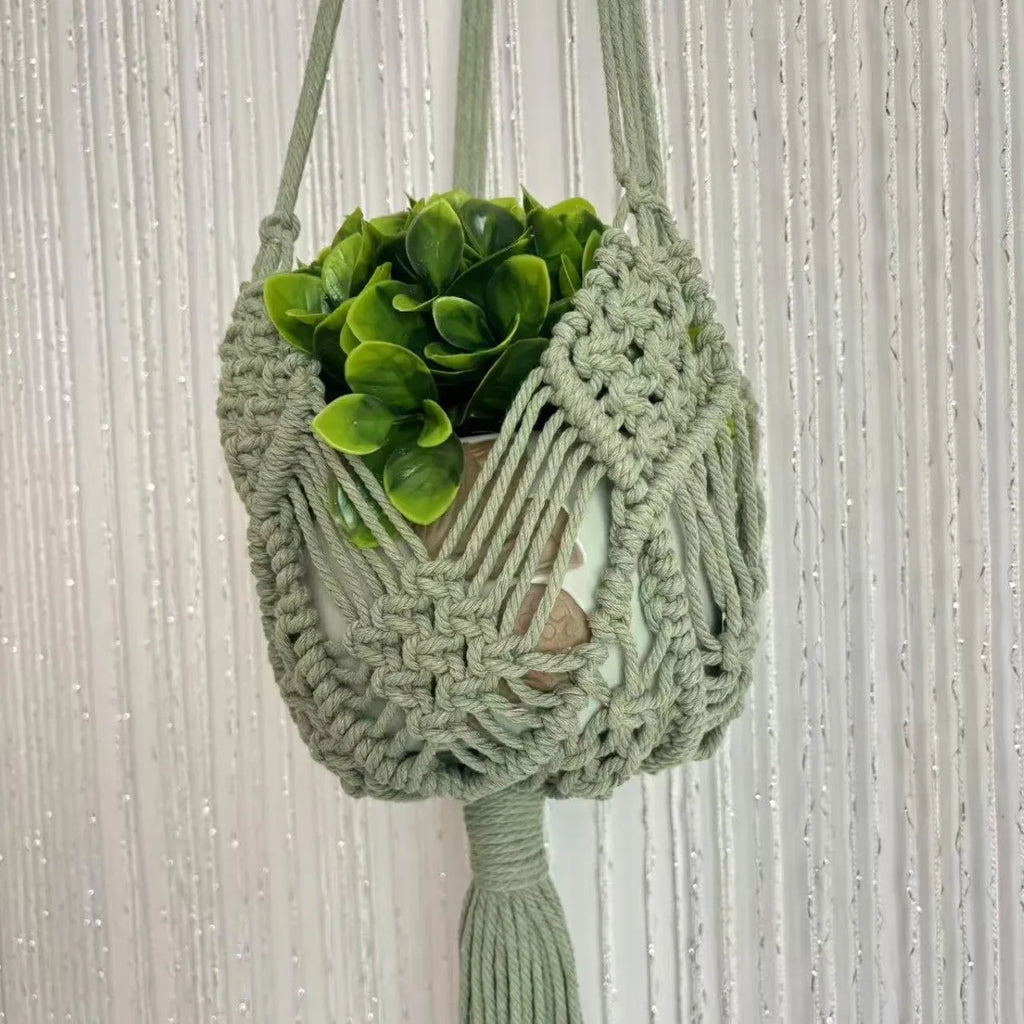 Hand-woven brown polyester cotton net pocket extension cord on a grey flower pot.