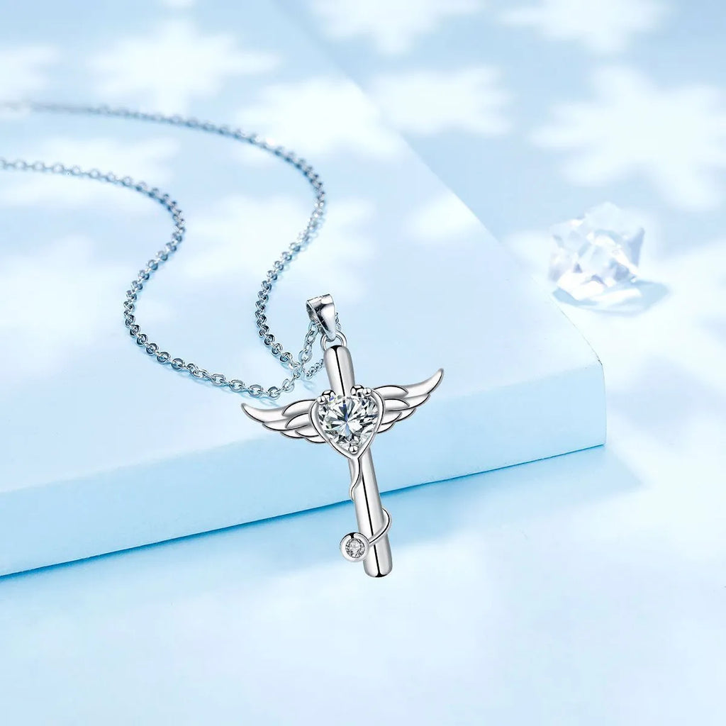 Close-up of a cross and angel wings charm on an adjustable stethoscope chain necklace.