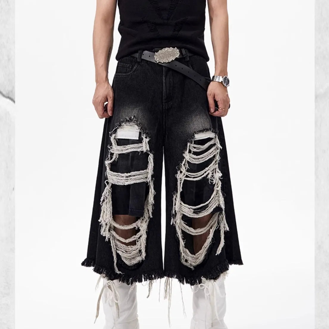 Women's black cropped wide leg jeans with distressed ripped patches and high waist