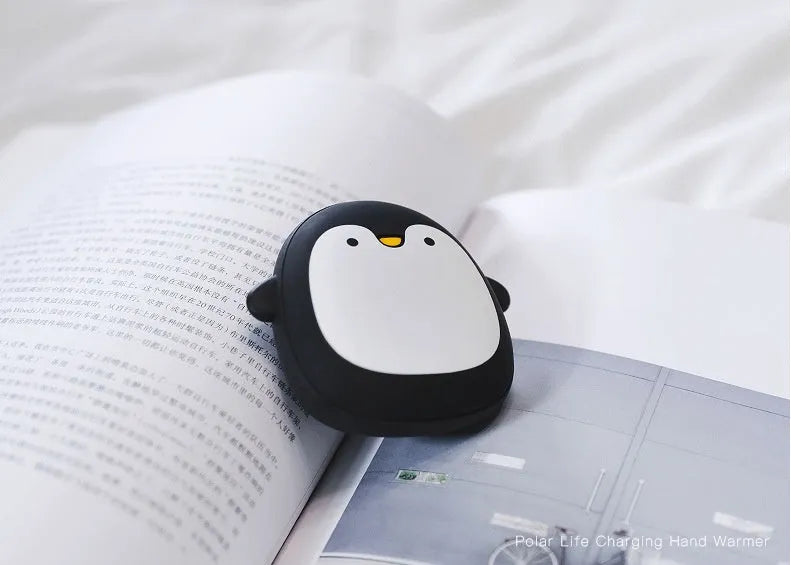 Cute cartoon penguin polar bear design USB rechargeable hand warmer and power bank unit.