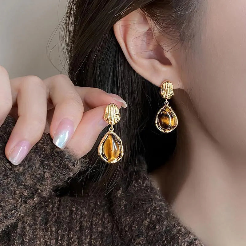 Handmade geometric tassel earrings in three electroplated styles: round piece, irregular, and water drop designs