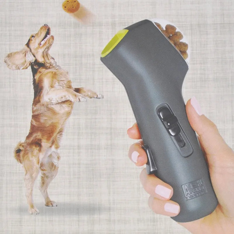 Grey plastic pet treat catapult launcher for dogs and cats on a neutral background