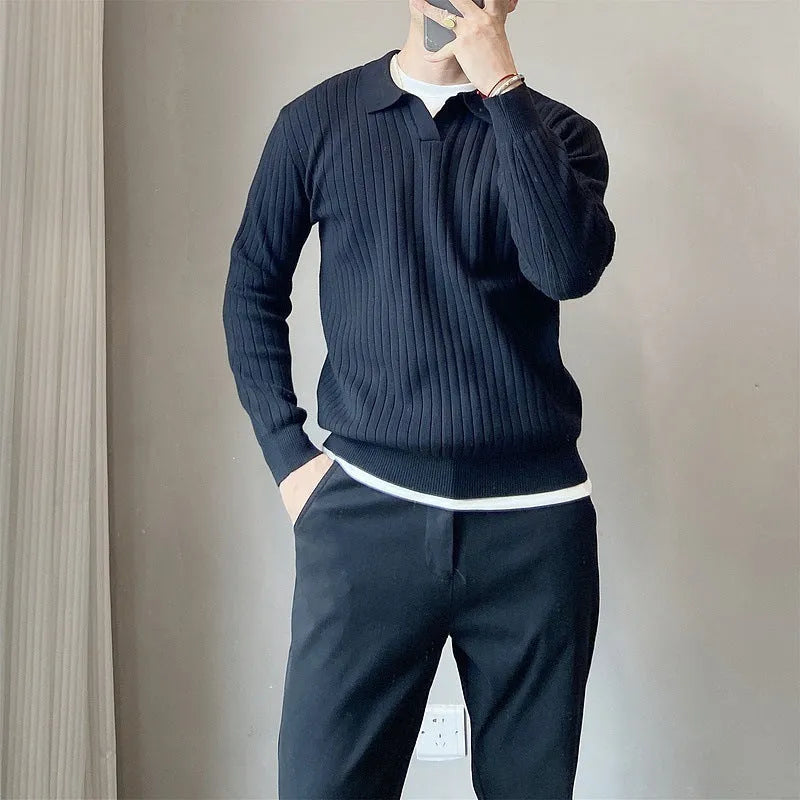 Man wearing a black and white striped knitted jumper with a lapel collar.