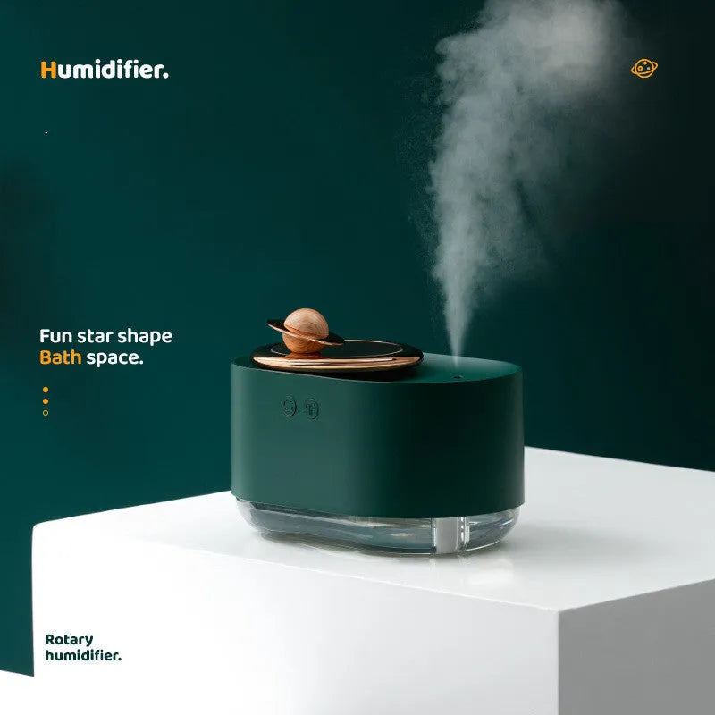Green rotating planet USB humidifier with night light on wooden desk