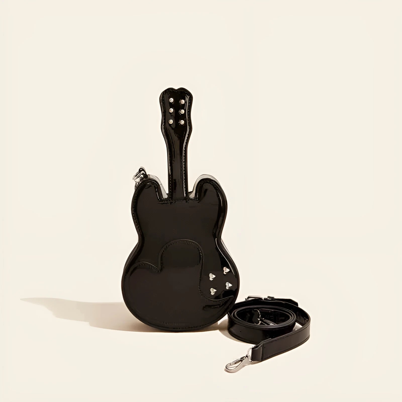 Guitar creative arts crossbody shoulder bag in black, showing front view and adjustable strap.
