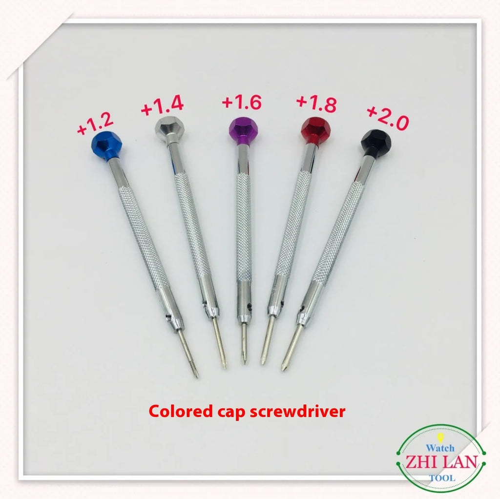 Six colour-coded watch repair screwdrivers with aluminium handles laid out on a surface.
