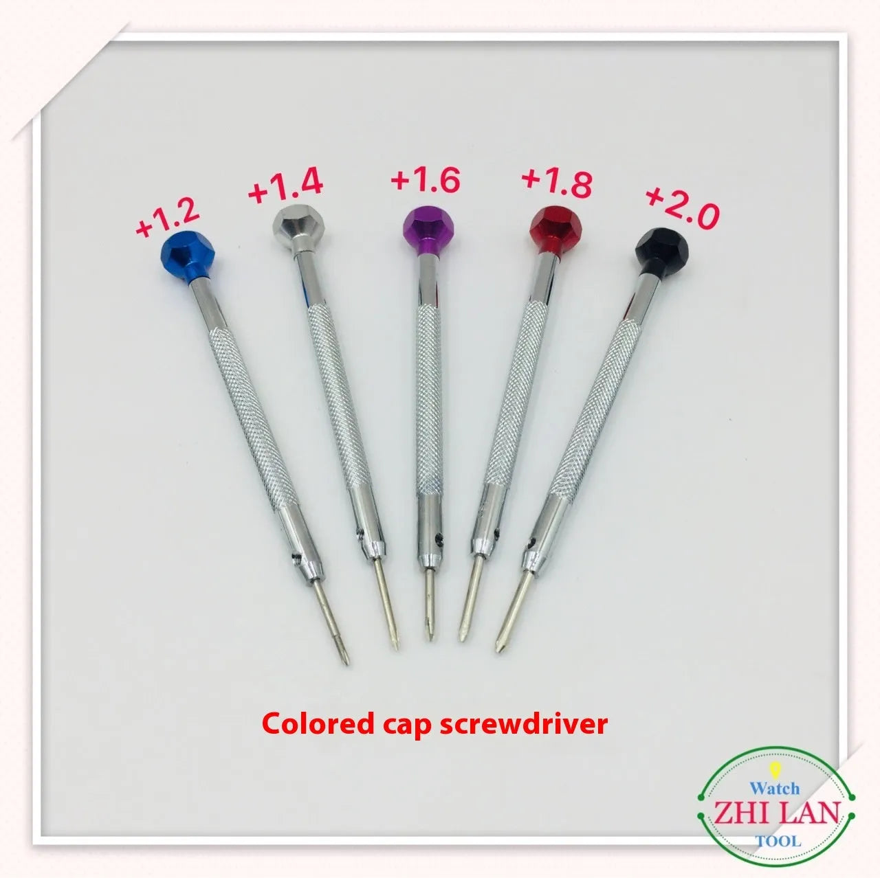 Six colour-coded watch repair screwdrivers with aluminium handles laid out on a surface.