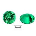 A selection of polished Columbia green cultivated emerald gemstones in various cuts and sizes on a white background.