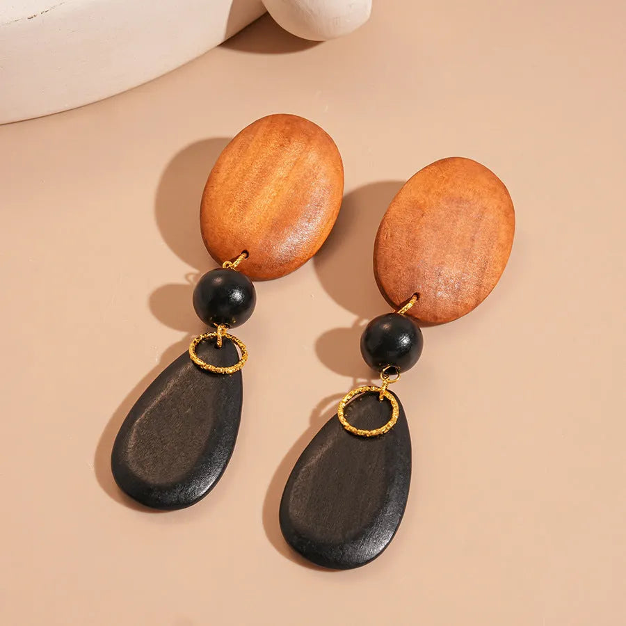 Handmade wooden retro earrings with elliptical shape in silver needle-brown-black colour combination