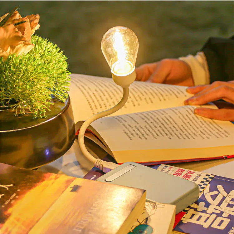 USB rechargeable folding tungsten filament night light in extended position showing warm white illumination
