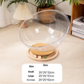 Transparent acrylic cat space capsule bed with turntable base on wooden floor
