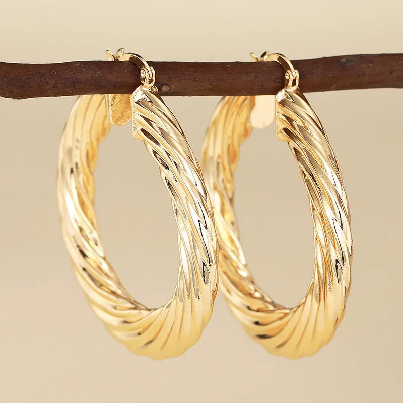 Geometric drop-shaped copper ear clips with ring and line design in electroplated finish