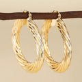 Geometric drop-shaped copper ear clips with ring and line design in electroplated finish