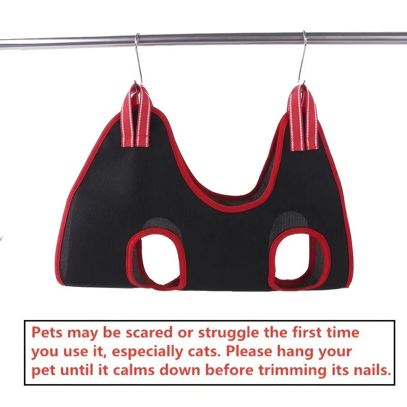 Pet grooming hammock restraint bag in use for dog nail trimming procedure