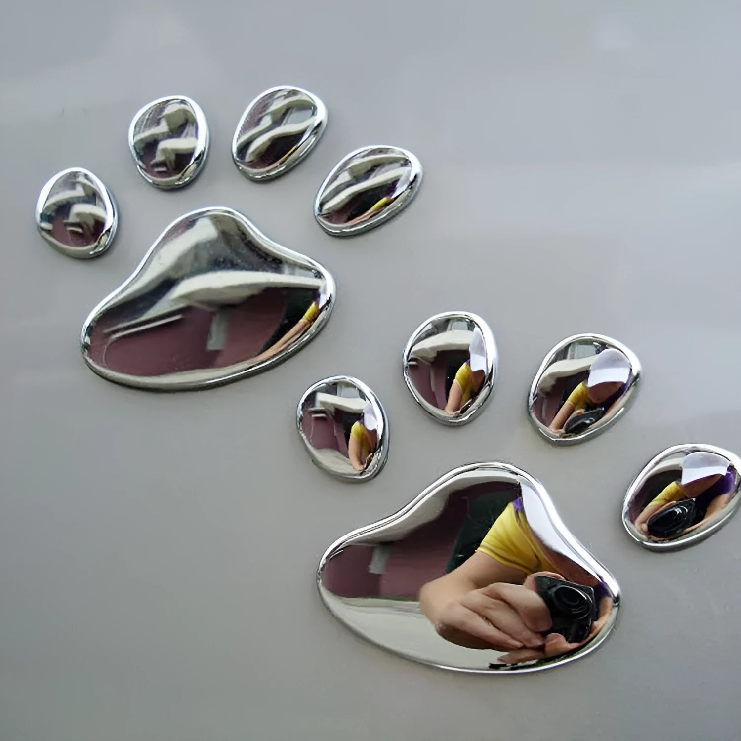 Hand-shaped brush outline car sticker with dog footprints, shown in black colour, measuring 7cm long.