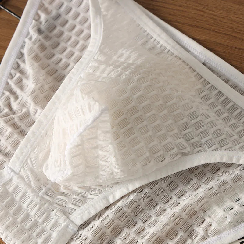 Men's low waist transparent lace underwear in black on a white background