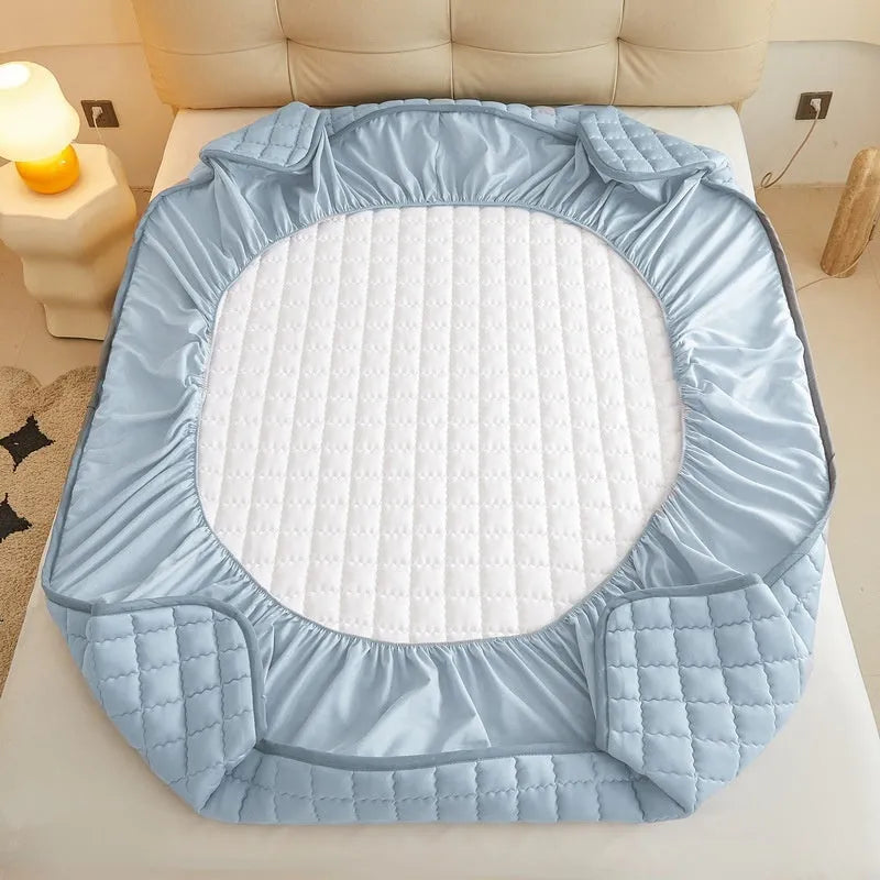 Class A waterproof washed cotton fitted sheet in light grey colour on a bed.