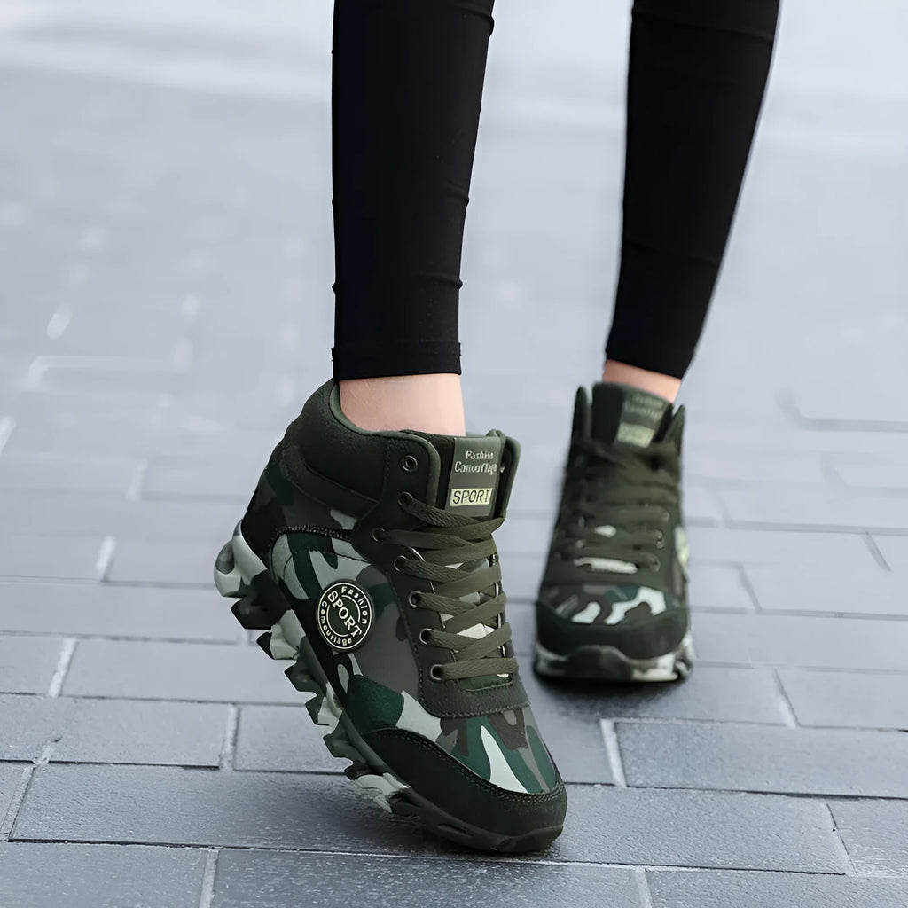 Green camouflage pattern women's canvas trainers with a raised rubber sole.