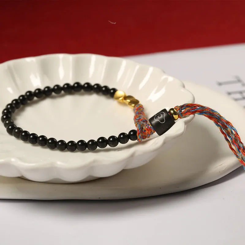 Hand-woven obsidian black wrist strap showing 4mm width and natural cord texture