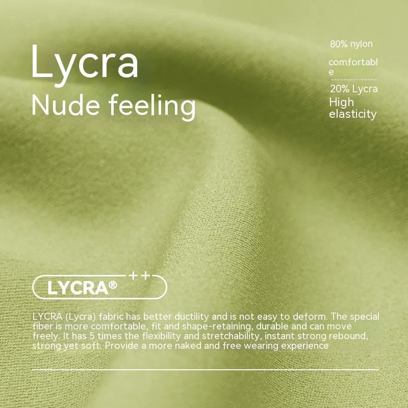 Women's leaf green high waist Lycra yoga shorts with four-point construction on a fitness background.