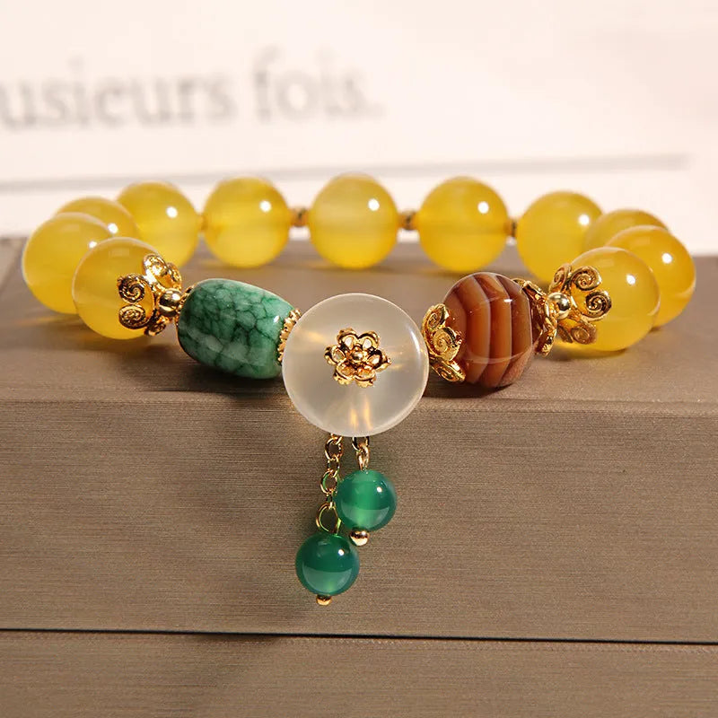 Yellow agate crystal bead bracelet with khaki silk cord and gold tone sliding closure.