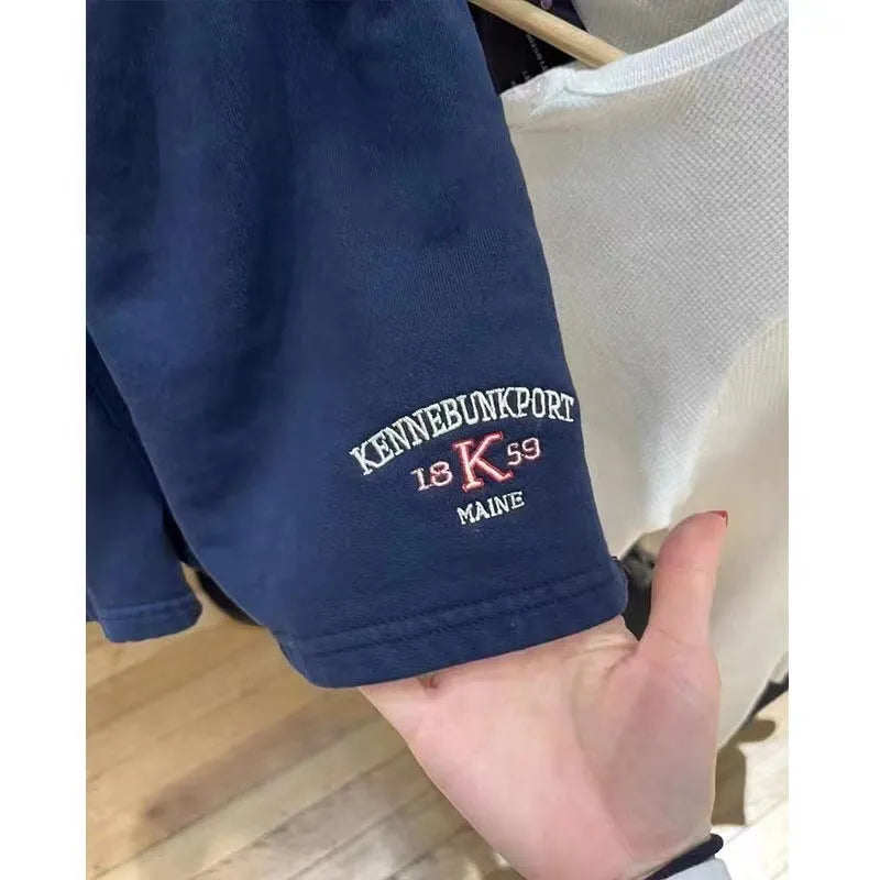 Dark blue cotton athletic hot pants with white flag embroidery and navy blue panels
