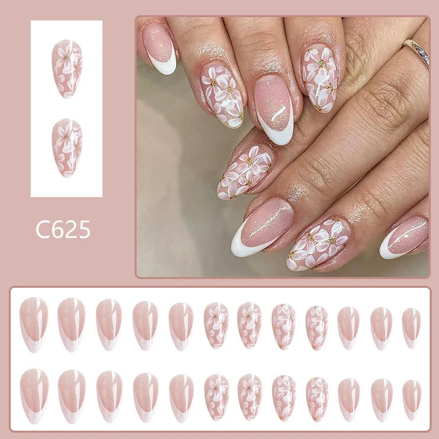 Short almond-shaped false nails with French style base and glitter powder flower decoration, colour C625.