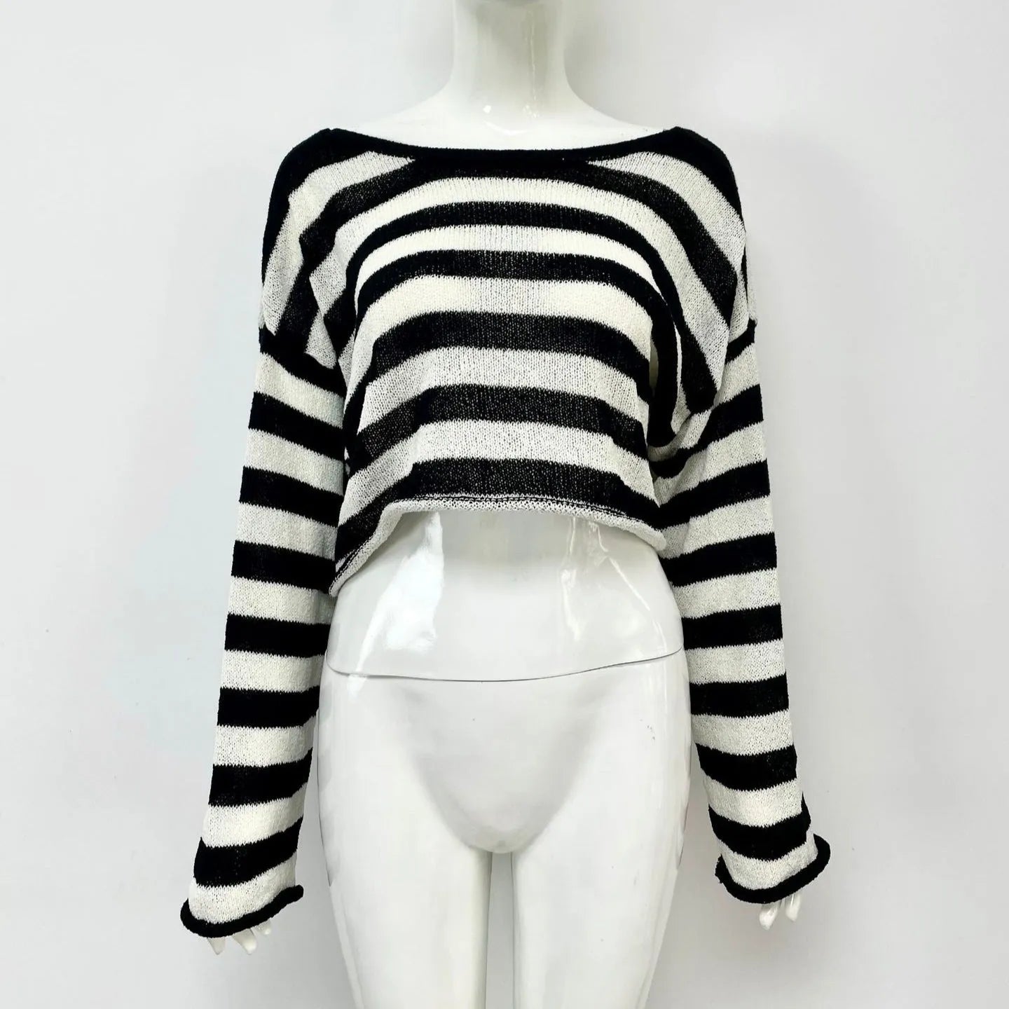 Women's black and white striped long-sleeved sweater with an exposed navel design, worn as a front and back wearable top.