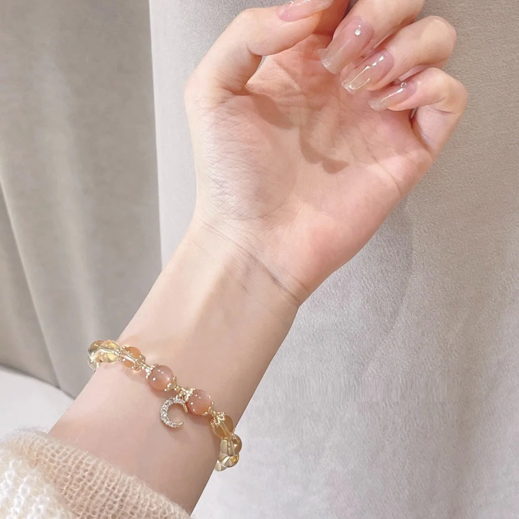 Chinese style women's crystal bracelet with electroplated 14K gilded finish and diamond-shaped moonstone golden sun stone elements