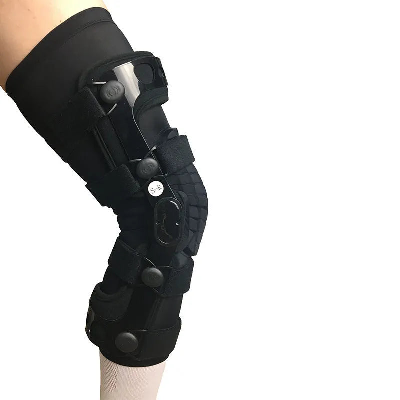 Black anterior ligament knee pad showing multi-material construction and sizing tags for left and right knees.