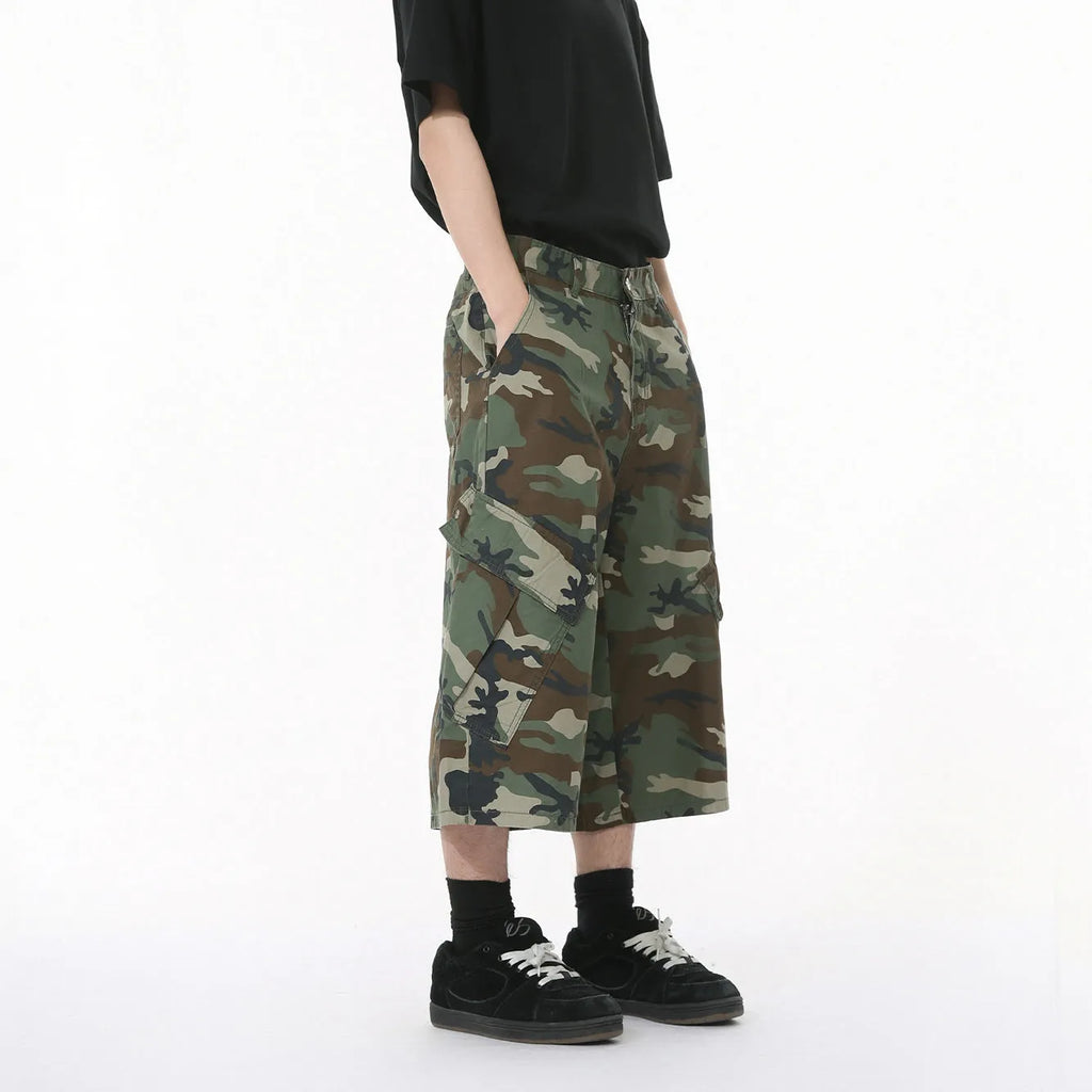 Men's camouflage coloured wide-leg cropped jeans with large side pockets.