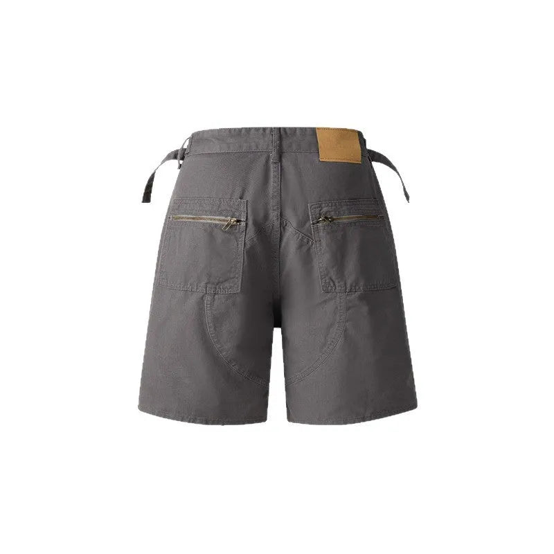 Retro loose-fit workwear shorts in washed cotton fabric with a zipper fly, shown in grey colour.