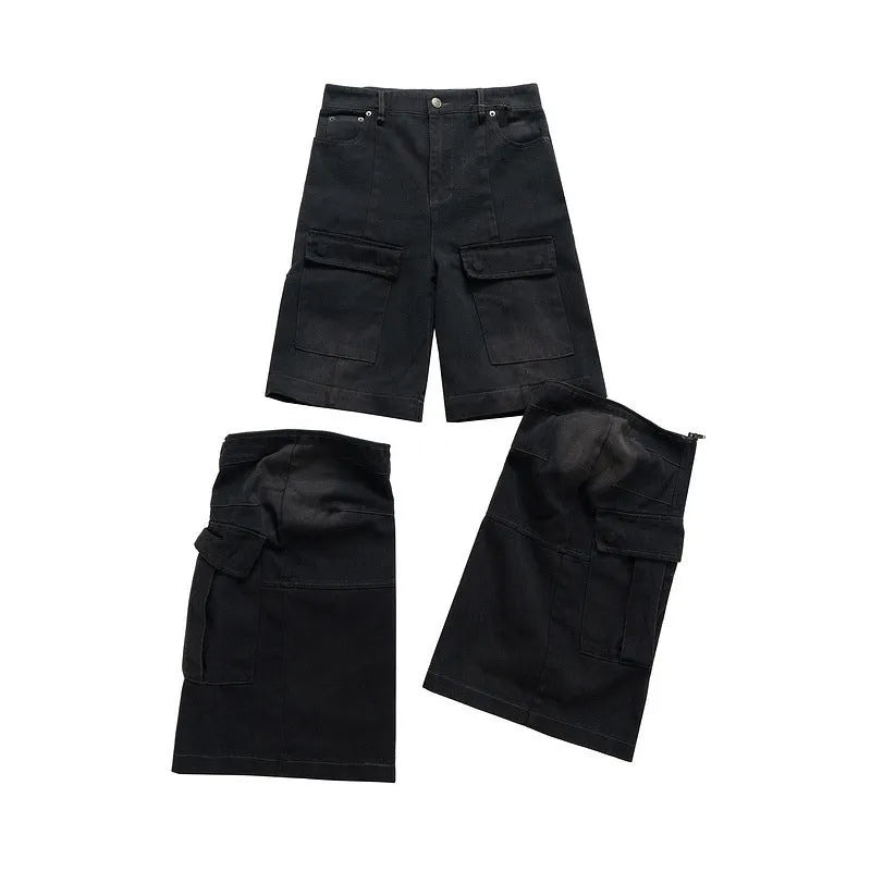 Black washed-out cotton overalls on a hanger, showing detachable pockets and a zip fly.