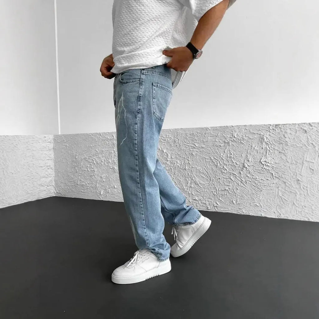 Men's blue straight-leg loose wide-leg denim jeans on a neutral background